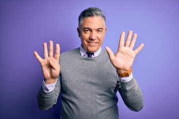 Wall Mural - Middle age handsome grey-haired man wearing elegant sweater over purple background showing and pointing up with fingers number nine while smiling confident and happy.