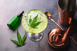 Cannabis cocktail margarita infused with CBD with marijuana leaf on dark background