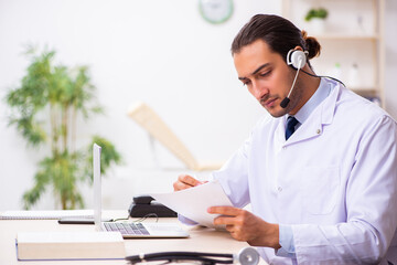 Young doctor listening to patient during telemedicine session