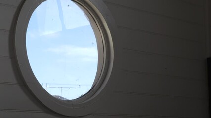 TILT UP, Round Window With Sunny Sky Outside