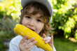 © Volodymyr - Autumn lifestyle. Homegrown organic food. Vegan children nutrition. Little boy eating corn on the cob.