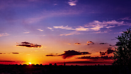 Wall Mural - bright sunlight through the clouds against a breathtaking evening sky at sunset. panorama, natural c