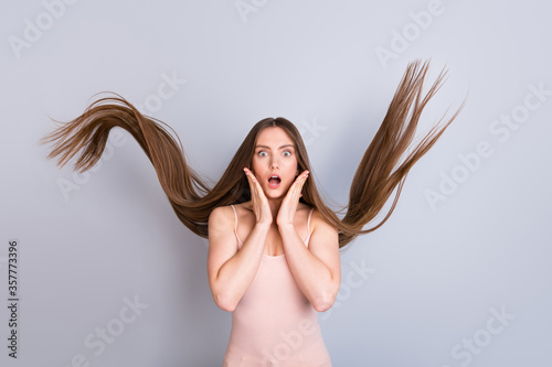 Portrait of her she nice attractive lovely pretty charming well-groomed amazed brown-haired girl facial expression wow effect wind blowing hair isolated on light gray pastel color background