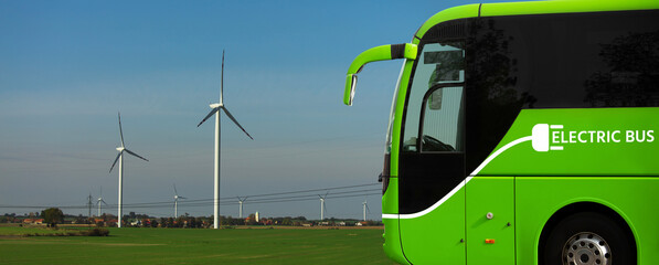 Electric tourist bus on a background of wind turbines