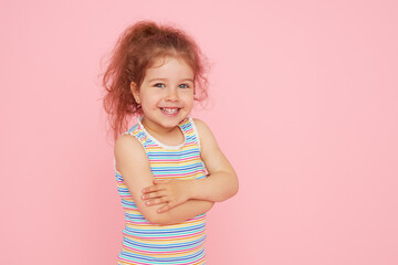 portrait of cute little child girl with a snow-white smile and healthy teeth over pink background. l
