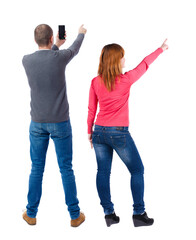 Wall Mural - Back view of couple in sweater with mobile phone.