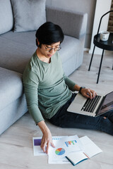 Sticker - Image of asian man working with laptop and documents while sitting