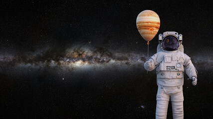 Wall Mural - astronaut with planet jupiter balloon, background with empty space