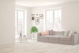 Fototapeta  - White living room with sofa and winter landscape in window. Scandinavian interior design. 3D illustration
