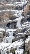 Vertical Crop Bridal Veil Falls With Frozen Water On Steep Slope During Winter In Provo Canyon