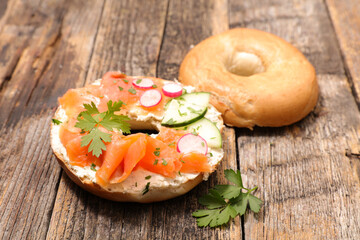 Wall Mural - bagel sandwich with smoked salmon, cheese cream and radish