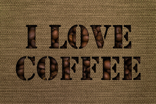 The text I love coffee made up of coffee beans on the background of a bag canvas fabric