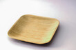 Square Areca Leaf Plate, eco-friendly disposable cutlery. Side view on a white background.
