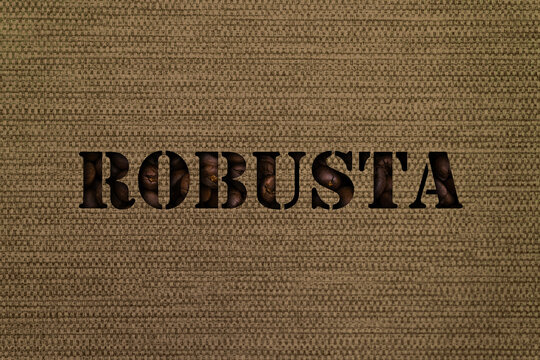 Text Robusta made up of coffee beans on a background of canvas fabric