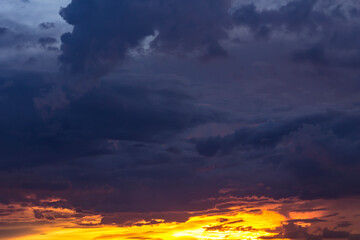 Romantic sunset sky with fluffy clouds