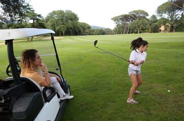 mother and daughter playing golf