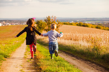 Wall Mural - Kids have fun are running on country road