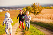© oksix - Group of children are playing on a country road