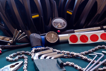 Bicycle accessories and tools in a dark key on a green background.