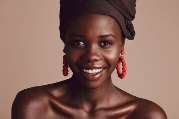Wall Mural - Beautiful african woman with turban against beige background