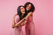 © Look! - Sincere girls with radiant smile pose in striped pink overalls. Summer shot in studio of funny models