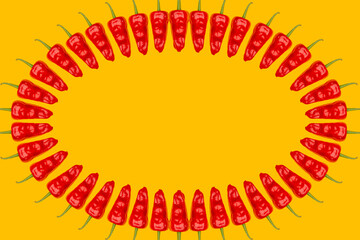 Wall Mural - Red chili pepper circle texture pattern on yellow background with copy space