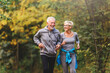 © lordn - Smiling senior couple jogging in the park