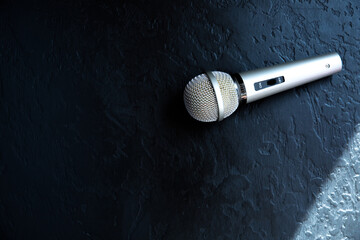 Microphone lying on the black background. Free time activities at home.