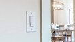 © Jason - Panorama crop Wall mounted electrical rocker light switch with blurry dining room background