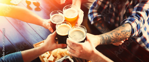 Group of friends toasting with beer in pub, closeup Tableau sur Toile