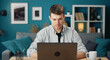 © MYDAYcontent - Front view of consumed young man working on laptop computer sitting at desk at home