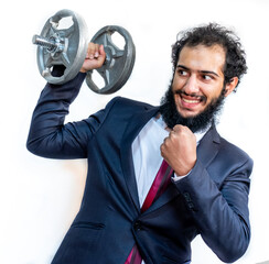 Wall Mural - Strong muslim man holding weights while wearing tuxedo