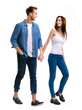 © vgstudio - Happy lovers concept - young couple walking together, going somewhere, holding hands. Isolated over white background. Caucasian models at full body length studio portrait image. Man and woman.
