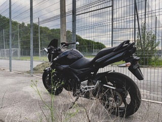 Wall Mural - Black motorcycle close-up on the street.