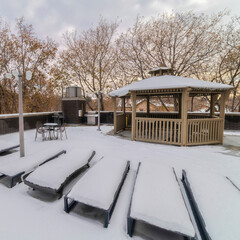 Square Snow covered recliner chair and outdoor gazebo