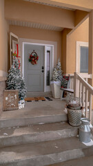 Wall Mural - Vertical Wet stairs at home entrance leading to front door with christmas tree and wreath