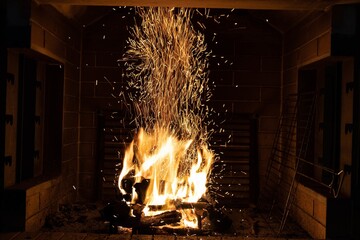 Poster - Sparkles of the burning wood inside a chimney