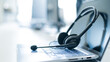 © Михаил Решетников - Call center operator desktop. Close-up of a headset on a laptop. Help desk. Workplace of a support service employee. Headphones with a microphone for voip on a computer keyboard.