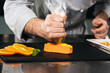© stockbusters - Chef cook cake at kitchen restaurant. Closeup chef hands making cake.