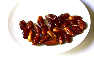 Ripe and delicious dates on a white plate