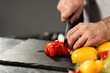 © stockbusters - Chef hands cut food at kitchen restaurant. Closeup chef hands slice vegetables.