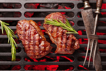 Wall Mural - Beef steaks cooking on grill