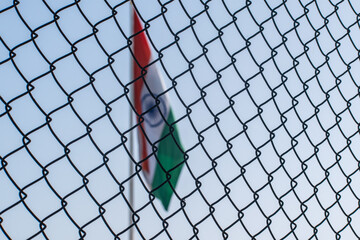 indian flag behind a grill 