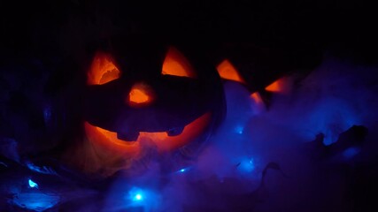 Wall Mural - Halloween carving pumpkins on leaves. There is mystical smoke or steam, all in smoke. glowing jack-o'-lantern. Cinemagraph loop. Still image, moving light.