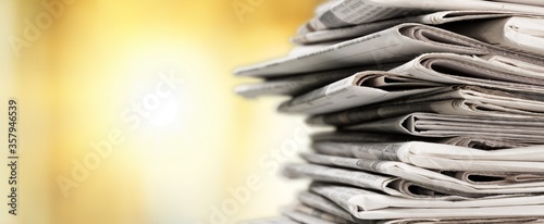 Photographie Pile of newspapers stacks on blur background