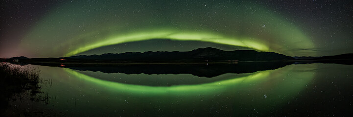 panorama of the aurora borealis, northern lights with stars. taken in yukon territory, north canada 