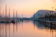 Sunset Over The Marina In Barcelona Spain With Water Reflections And View Of Mont Juic