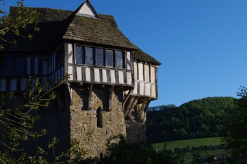 Poster - Stone building with windows and a roof in the forest