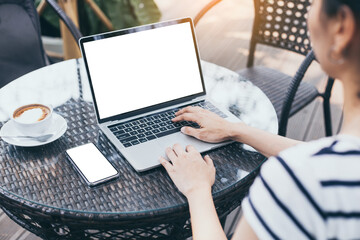 computer,cell phone mockup image.hand woman work using laptop texting mobile.blank screen with white background for advertising,contact business search information on desk in cafe.marketing,design