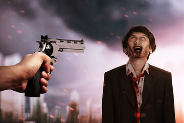 Poster - Hand pointing a gun to zombies on the city